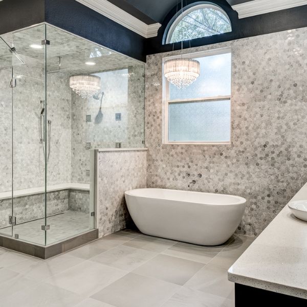 Elegant bathroom remodel featuring marble countertops, modern fixtures, and a spacious shower.