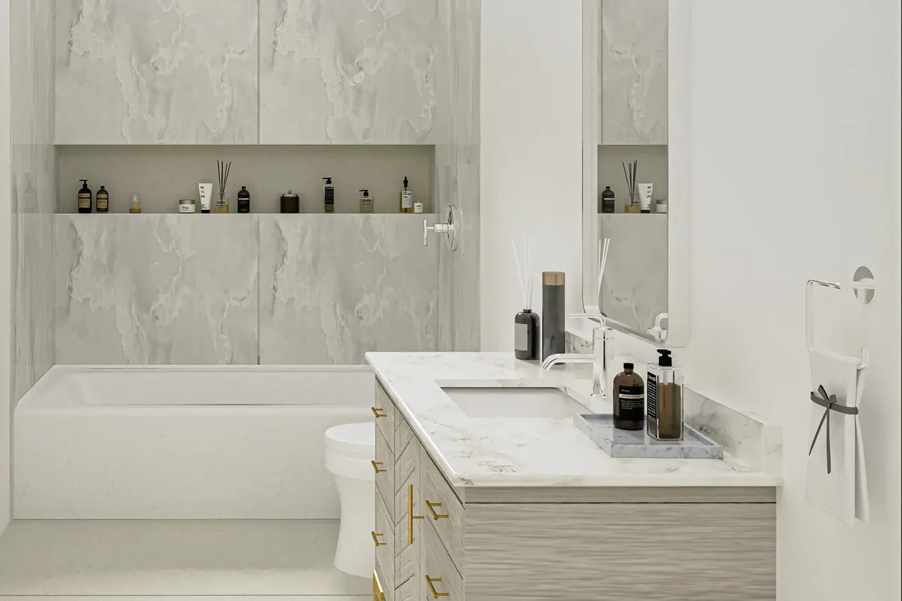 Tub and shower design with groutless gray marble-look slab walls, a long niche and a white tub