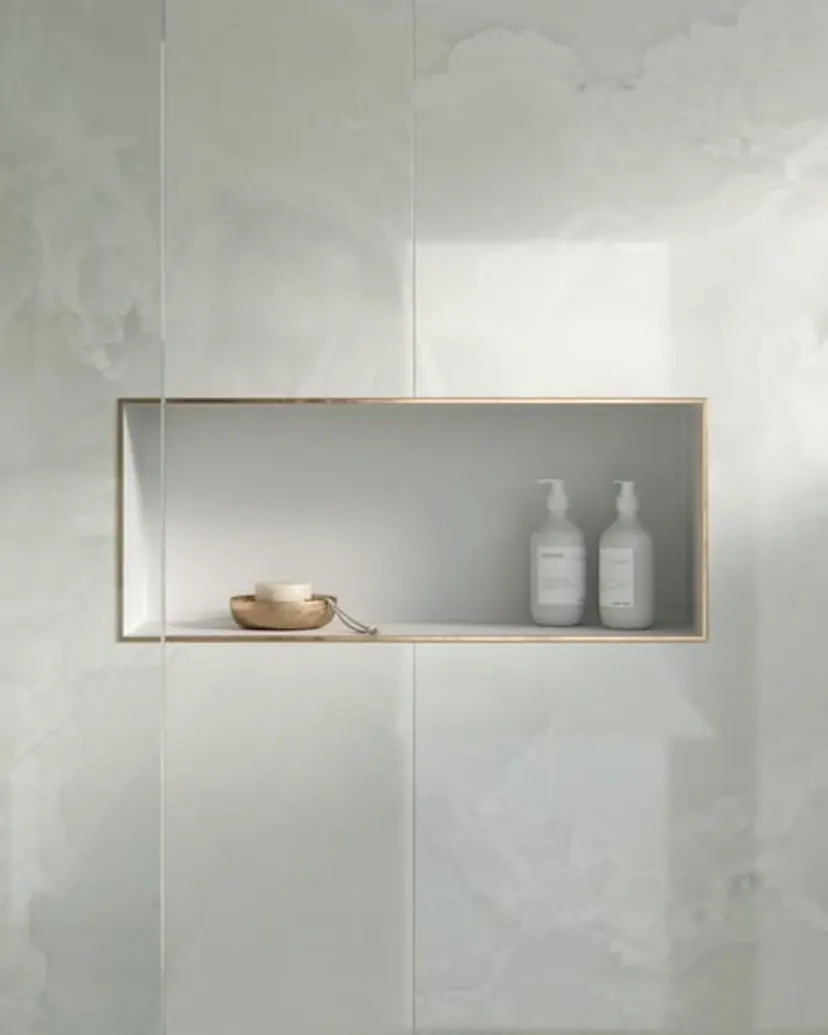 Denton bathroom remodel idea: groutless Dekton shower wall with a long brass-trimmed niche