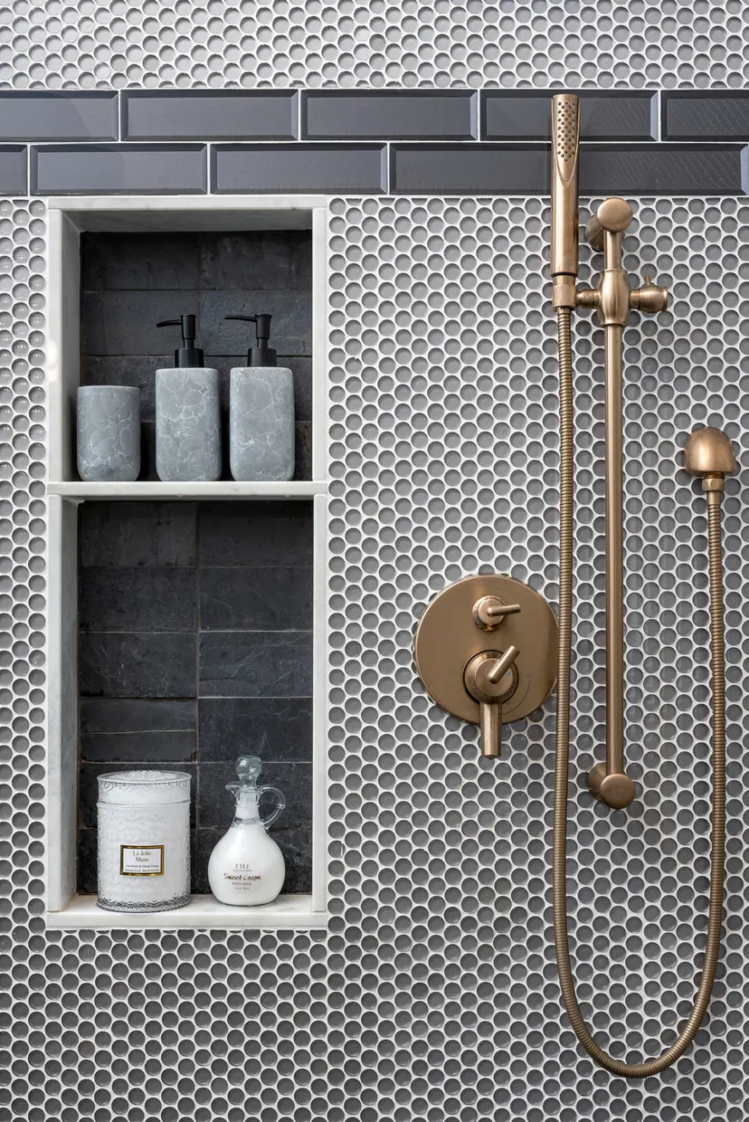 Denton bathroom remodel idea: shower in gray penny tile with a niche and brushed brass fixtures