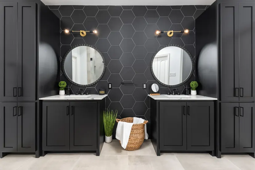 Farmers Branch bathroom remodel idea: black double vanity, round mirrors and a black hexagon tile wall