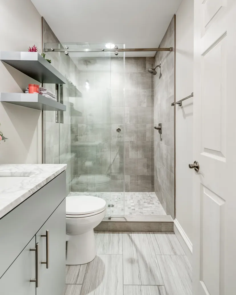 Frisco bathroom remodel idea: tub to shower conversion with a sliding glass door and gray tile