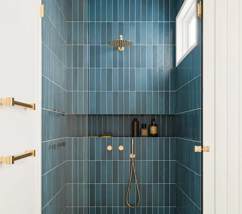 Plano bathroom remodel idea: tub to shower conversion in deep blue tile with gold fixtures