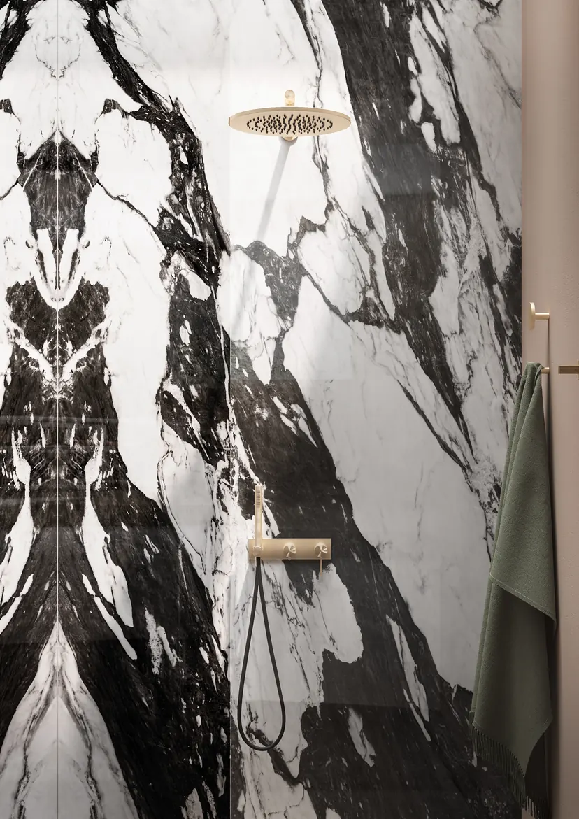 Rowlett bathroom remodel idea: book-matched marble slab shower with a brushed gold rain head